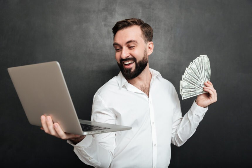 Portrait successful businessman white shirt holding fan money dollar banknotes silver notebook both hands dark gray