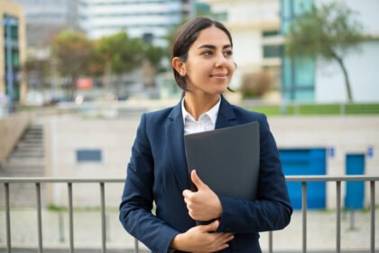 Happy businesswoman holding folder 1