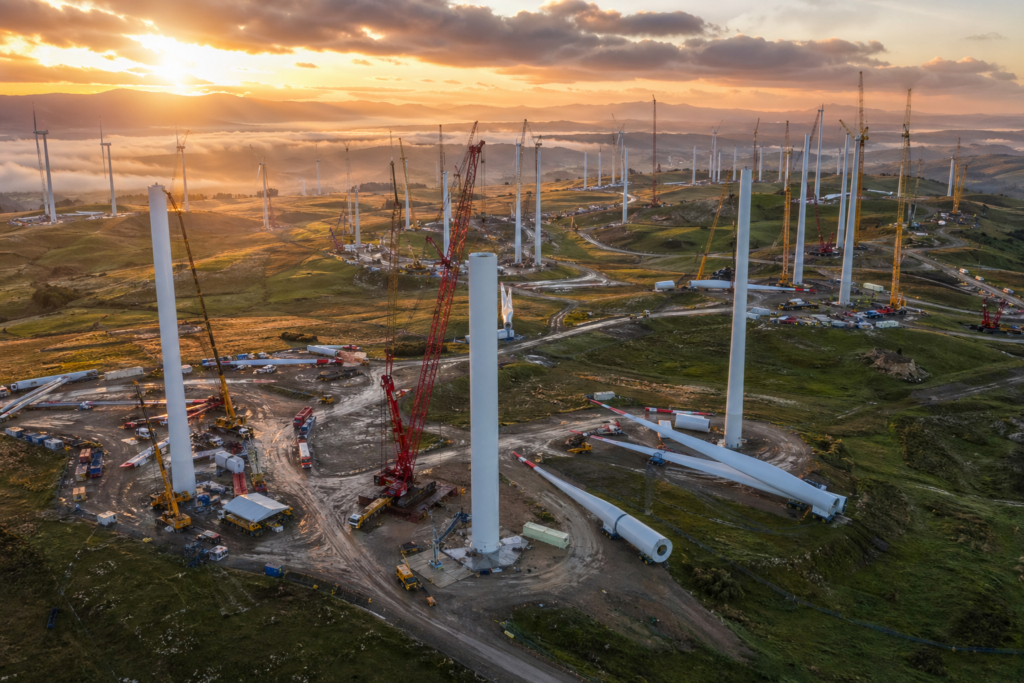 Suzlon Energy 6.4 GW order book — active wind turbine construction site in India with cranes and turbine components at dawn